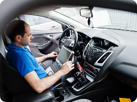 car-repair-maintenance-theme-electric-mechanic-uniform-working-auto-service-making-car-diagnostics-using-obd-device-with-laptop 1